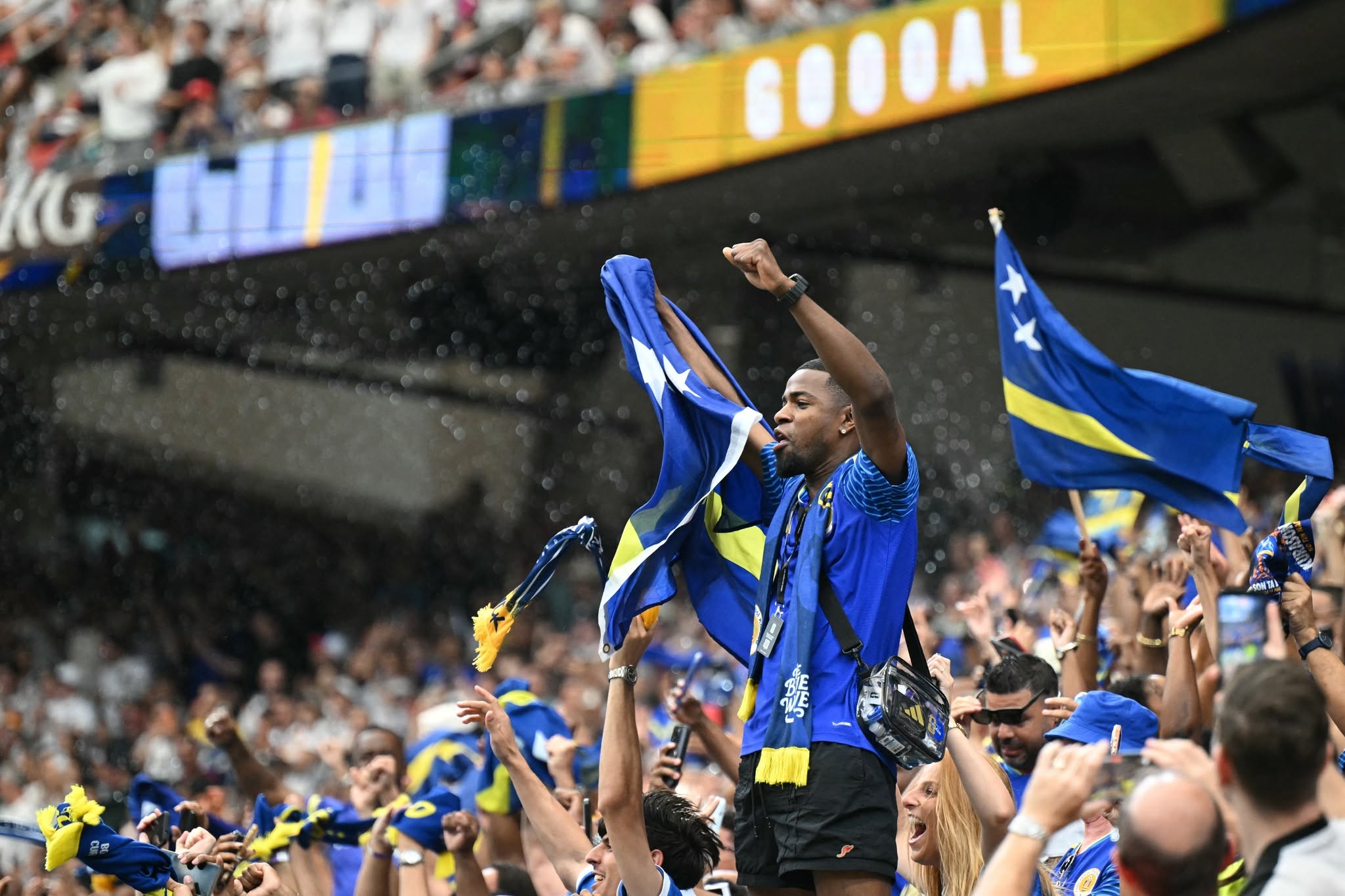 Curacao supporters celebrate thei team scoring their first goal  during the 2026 World Cup Group E football match between Germany and Curacao at the Houston Stadium in Houston on June 14, 2026.  (Photo by RONALDO SCHEMIDT / AFP via Getty Images)