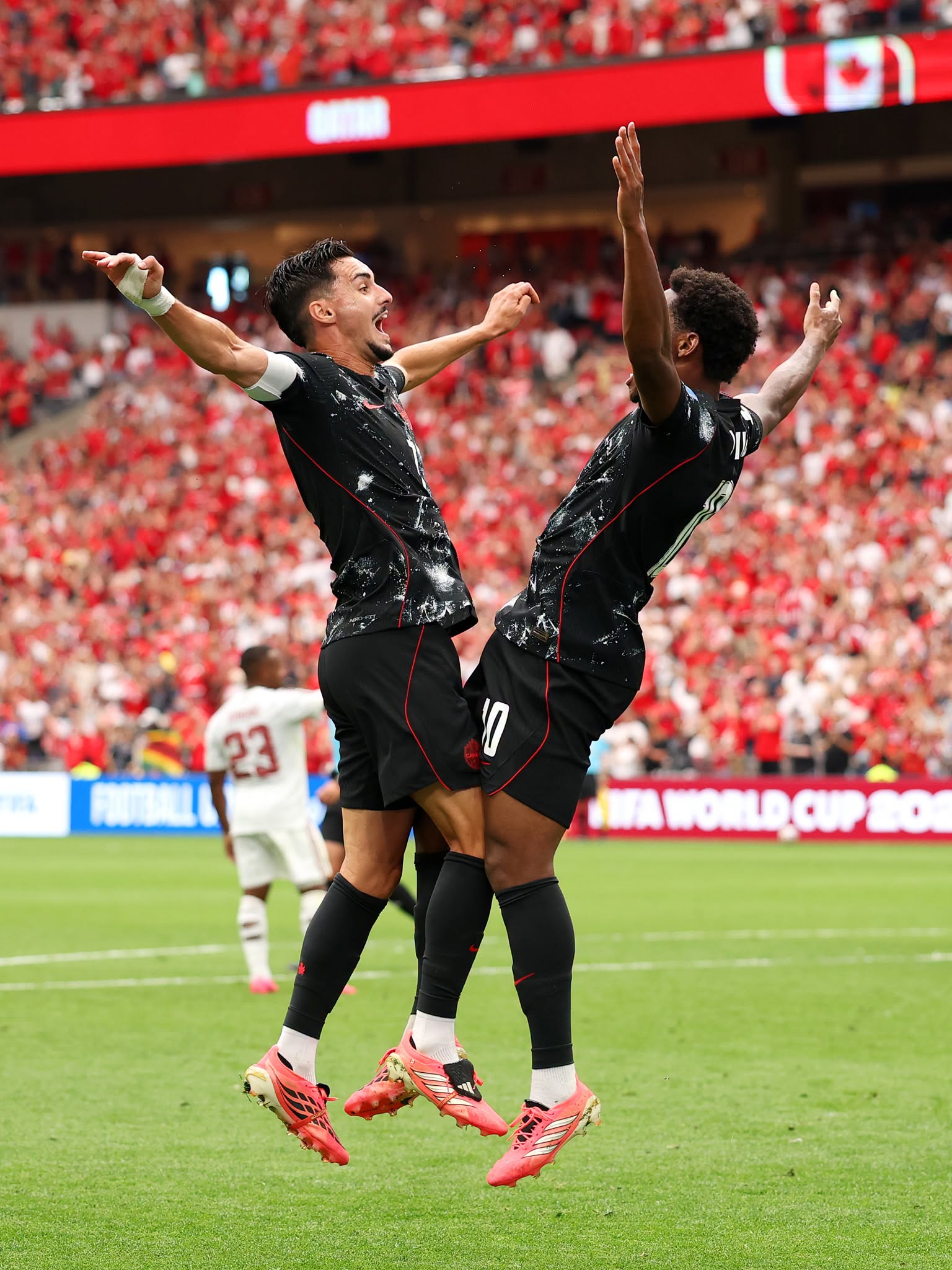 VANCOUVER, BRITISH COLUMBIA - JUNE 18: Jonathan David #10 of Canada celebrates with teammate Stephen Eustaquio #7 after scoring his team's third goal during the FIFA World Cup 2026 Group B match between Canada and Qatar at BC Place Vancouver on June 18, 2026 in Vancouver, British Columbia. (Photo by Fran Santiago/Getty Images)