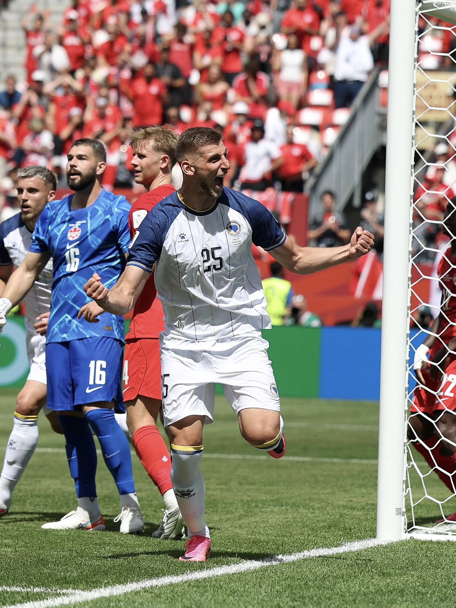 TORONTO, ONTARIO - JUNE 12: Jovo Lukic #25 of Bosnia and Herzegovina celebrates scoring his team's first goal during the FIFA World Cup 2026 Group B match between Canada and Bosnia and Herzegovina at Toronto Stadium on June 12, 2026 in Toronto, Ontario. (Photo by Charlotte Wilson/Getty Images)