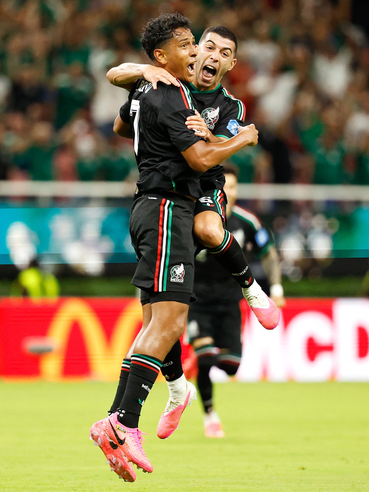 Mexico's midfielder #07 Luis Romo celebrates with teammate midfielder #06 Erik Lira scoring his team's first goal during the 2026 World Cup Group A football match between Mexico and South Korea at the Guadalajara Stadium in Zapopan on June 18, 2026.  (Photo by Ulises RUIZ / AFP via Getty Images)