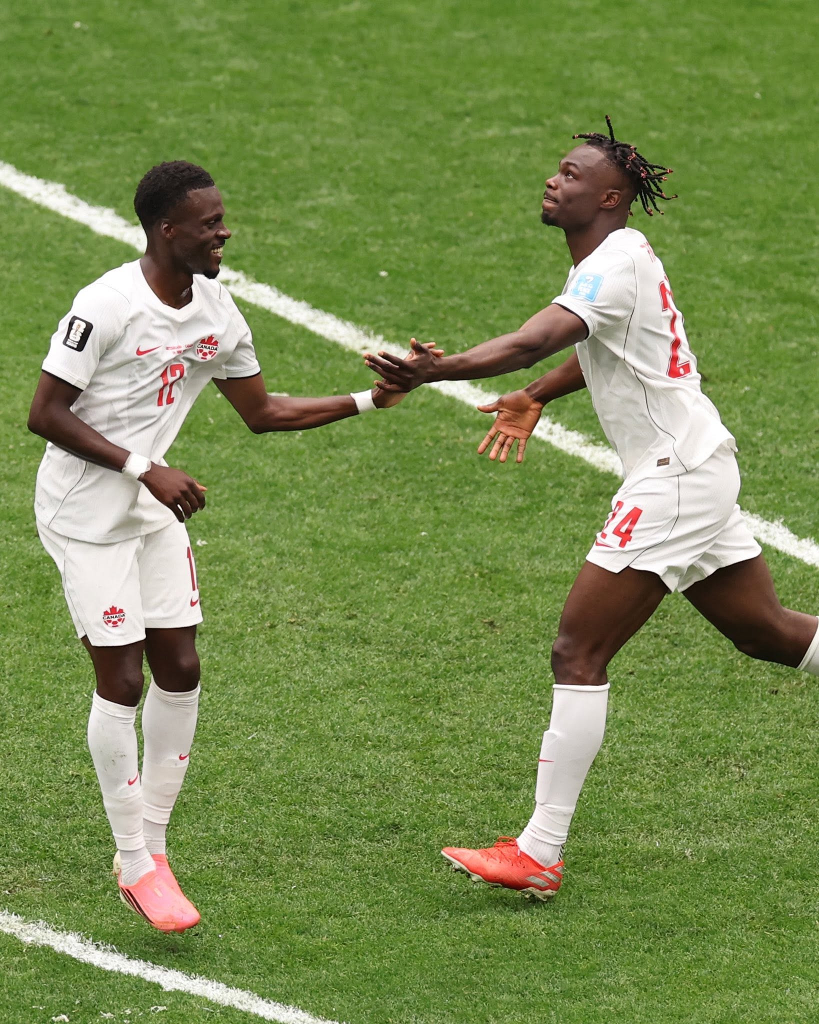 VANCOUVER, BRITISH COLUMBIA - JUNE 24: Promise David #24 of Canada celebrates with teammate Tani Oluwaseyi #12 of Canada after scoring his team's first goal during the FIFA World Cup 2026 Group B match between Switzerland and Canada at BC Place Vancouver on June 24, 2026 in Vancouver, British Columbia. (Photo by Fran Santiago/Getty Images)